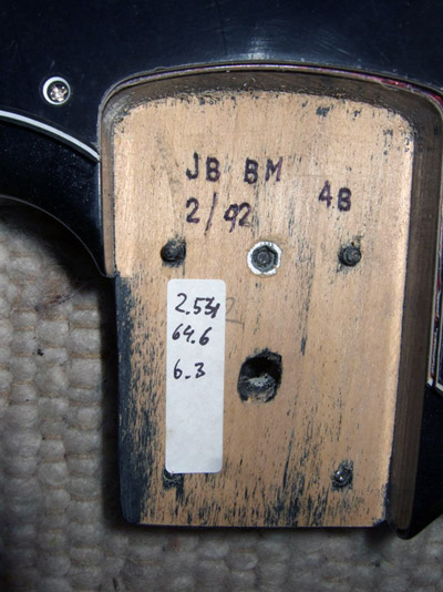 This tells us that the model is a J-Bass (JB), in Black Metallic (BM), with Fender spec. pickups (4B), manufactured in February 1992 (2/92).<br/> The numbers on the white stickers are the neck pocket dimensions.